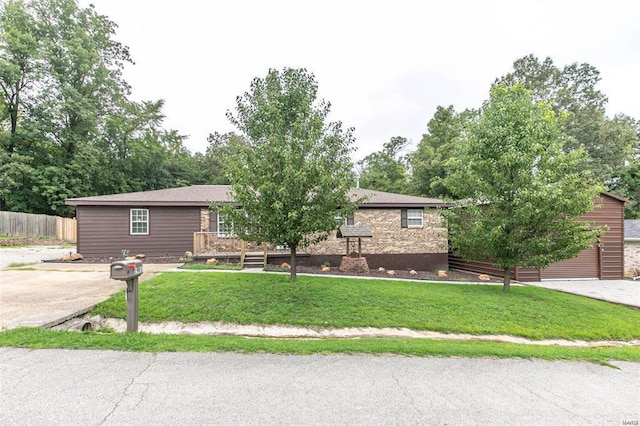 view of front of property with a garage and a front lawn