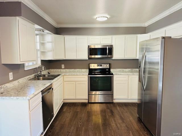 kitchen featuring white cabinetry, appliances with stainless steel finishes, light stone countertops, and sink