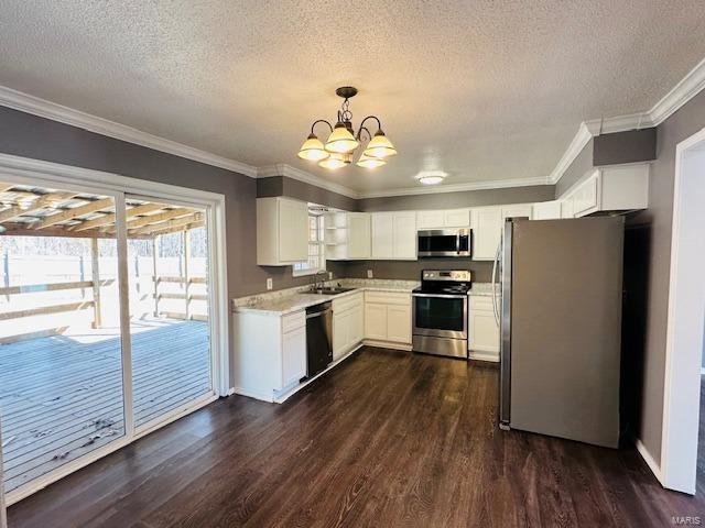 kitchen with sink, white cabinetry, appliances with stainless steel finishes, dark hardwood / wood-style floors, and pendant lighting