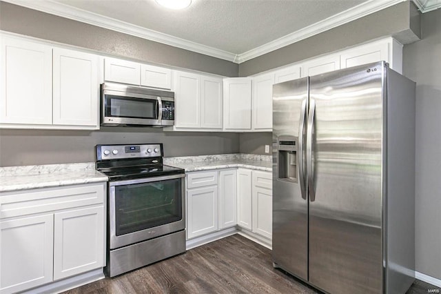 kitchen featuring crown molding, stainless steel appliances, and white cabinets