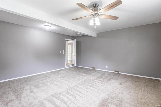 empty room featuring ceiling fan and carpet