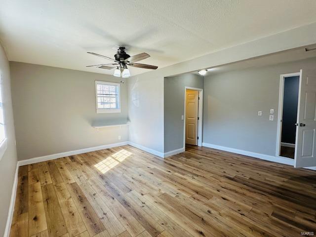 spare room featuring ceiling fan and light wood-type flooring