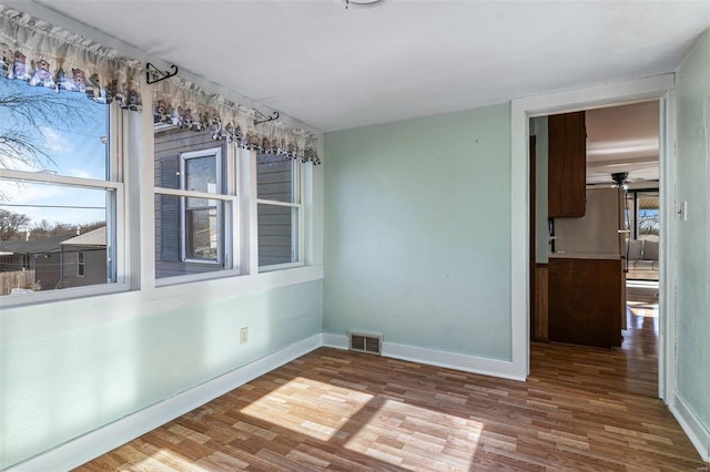 empty room featuring hardwood / wood-style floors and ceiling fan