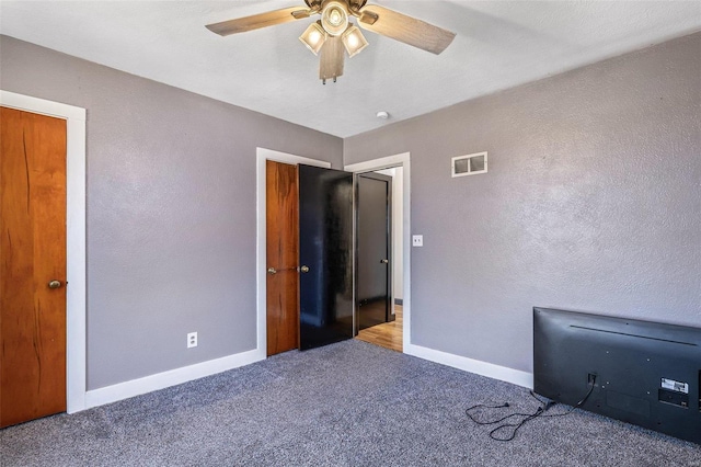 unfurnished bedroom featuring carpet flooring and ceiling fan