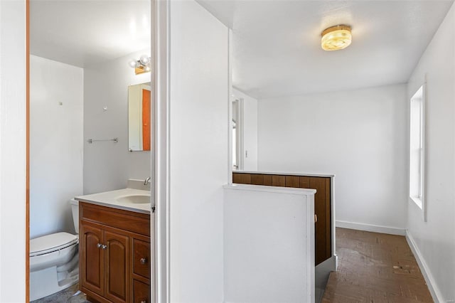 bathroom featuring vanity and toilet