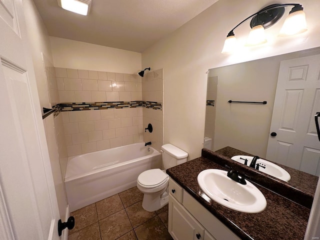 full bathroom featuring tiled shower / bath, tile patterned floors, toilet, and vanity