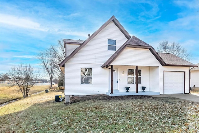 view of front facade with a garage, a front lawn, and covered porch