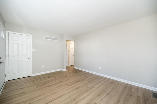 spare room with light hardwood / wood-style floors