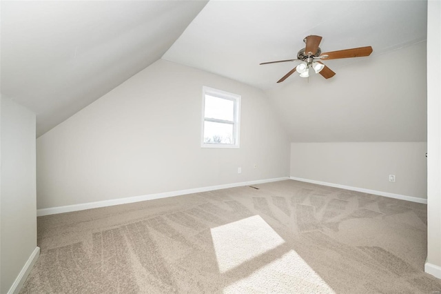 additional living space with ceiling fan, lofted ceiling, and carpet