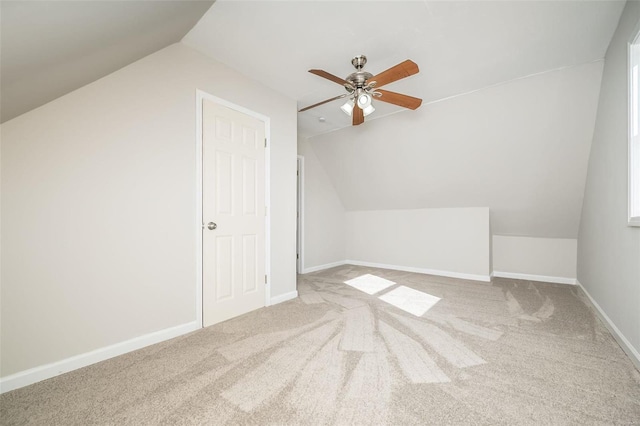 additional living space featuring lofted ceiling, carpet, and ceiling fan