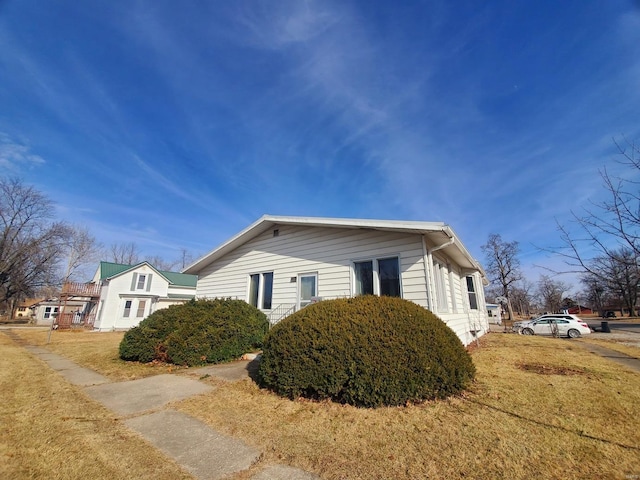 view of home's exterior with a yard