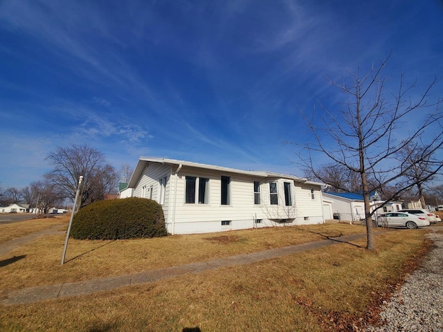 view of side of property with a yard