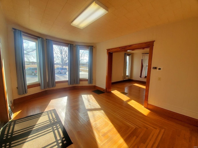 unfurnished room featuring hardwood / wood-style flooring and a wealth of natural light