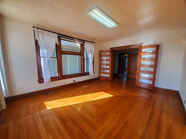 unfurnished room featuring hardwood / wood-style flooring