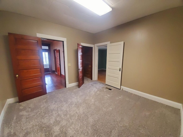 unfurnished bedroom with carpet flooring