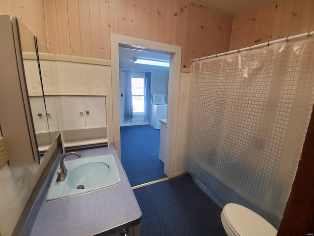 full bathroom with vanity, toilet, shower / bath combo with shower curtain, and wood walls