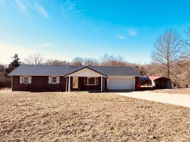 ranch-style home with a carport and a garage