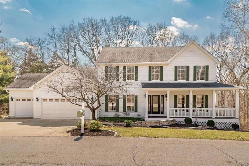 view of front facade featuring a garage and covered porch