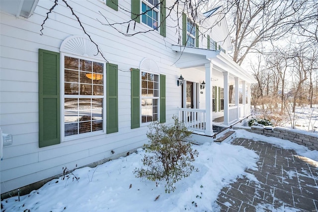 view of snow covered property entrance