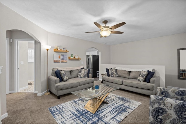 living room with ceiling fan and carpet flooring