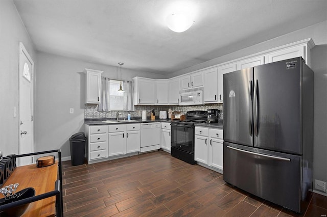 kitchen featuring pendant lighting, white appliances, dark hardwood / wood-style floors, and white cabinets