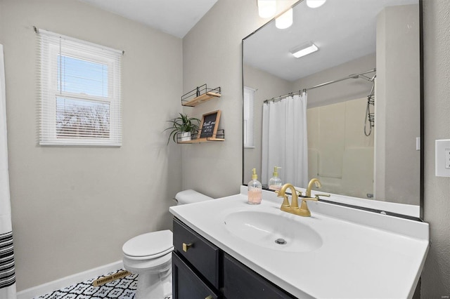 bathroom with vanity, toilet, and walk in shower