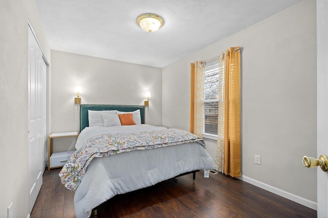 bedroom with dark hardwood / wood-style floors and a closet