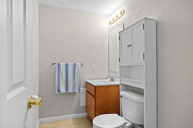 bathroom featuring vanity, tile patterned flooring, and toilet