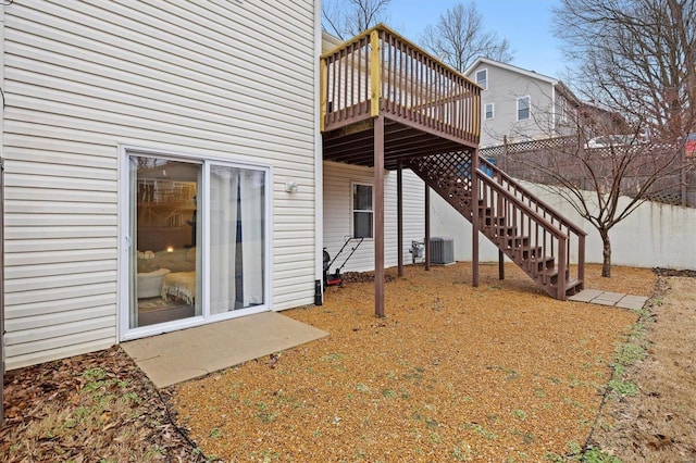 back of house with cooling unit and a deck