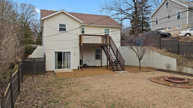 back of house featuring an outdoor fire pit