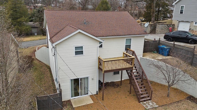 back of property with a wooden deck