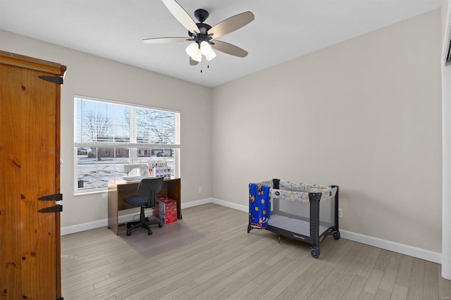 office with ceiling fan and light wood-type flooring