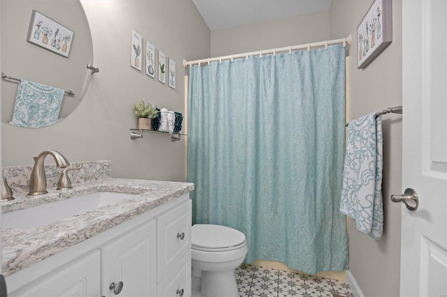 bathroom with walk in shower, vanity, and toilet