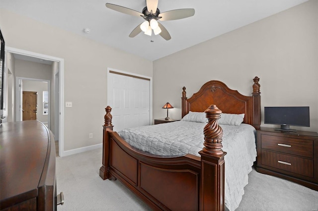 carpeted bedroom featuring a closet and ceiling fan