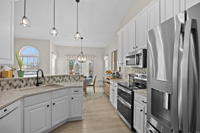 kitchen with pendant lighting, sink, white cabinetry, stainless steel appliances, and tasteful backsplash