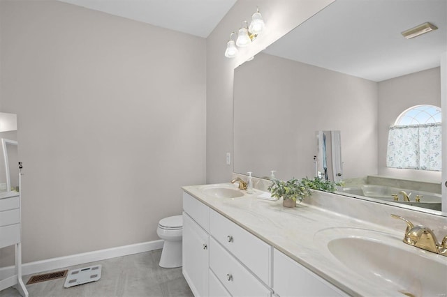 bathroom featuring vanity, tile patterned flooring, a bathtub, and toilet