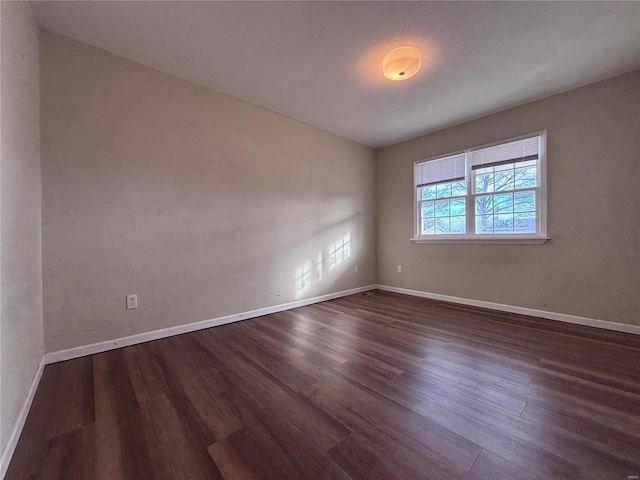 spare room with dark hardwood / wood-style floors