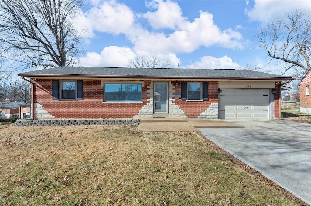 ranch-style home with a garage and a front lawn