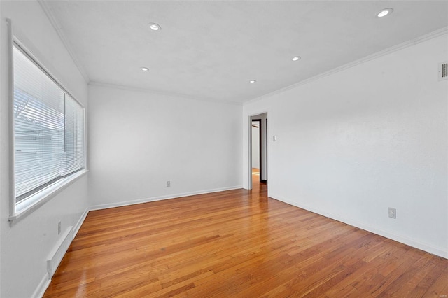 unfurnished room featuring ornamental molding and light hardwood / wood-style floors