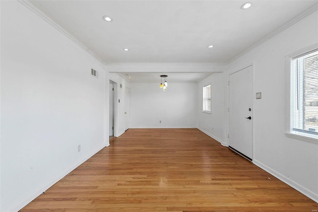 interior space featuring ornamental molding and light hardwood / wood-style floors