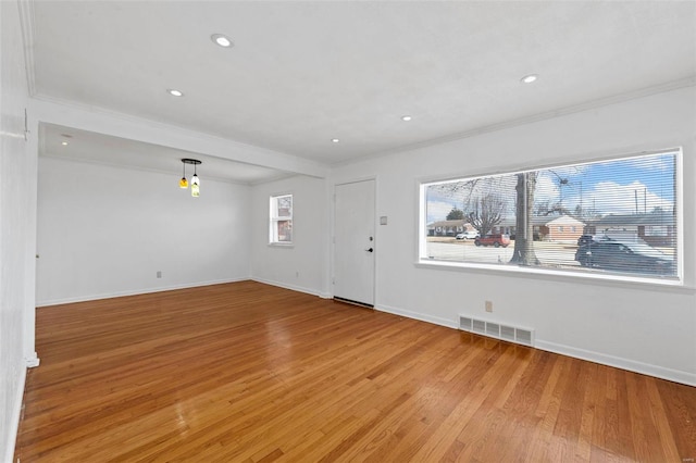 interior space with light hardwood / wood-style flooring and ornamental molding