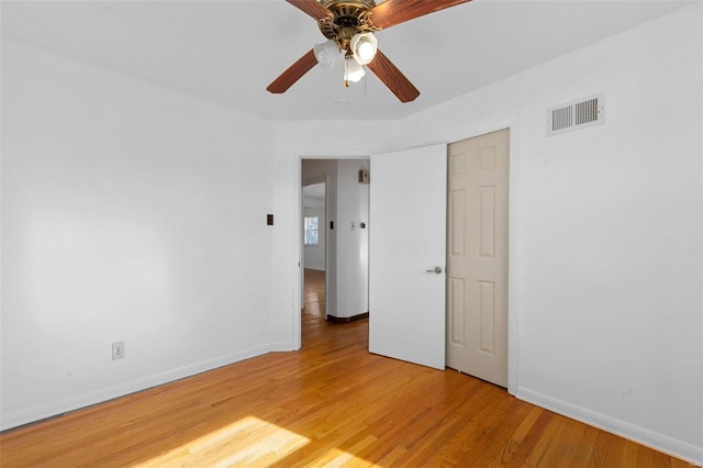 spare room featuring hardwood / wood-style floors and ceiling fan