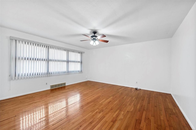 spare room with wood-type flooring and ceiling fan