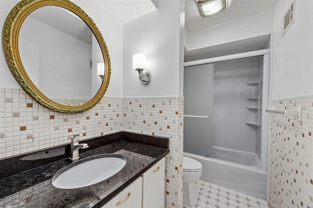 full bathroom featuring vanity, shower / bathing tub combination, tile walls, and toilet