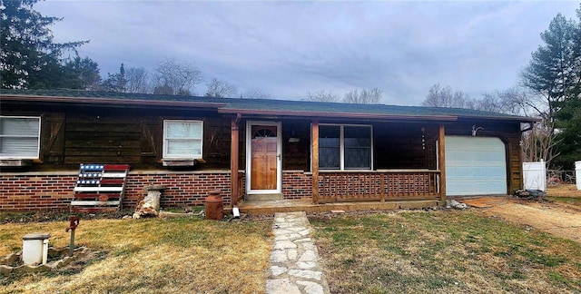 view of front of property featuring a garage and a front lawn