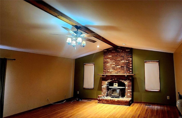 unfurnished living room featuring ceiling fan, hardwood / wood-style floors, and vaulted ceiling with beams