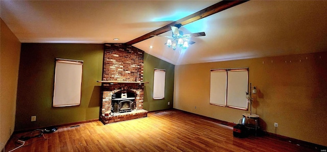 unfurnished living room featuring hardwood / wood-style flooring, ceiling fan, and vaulted ceiling with beams