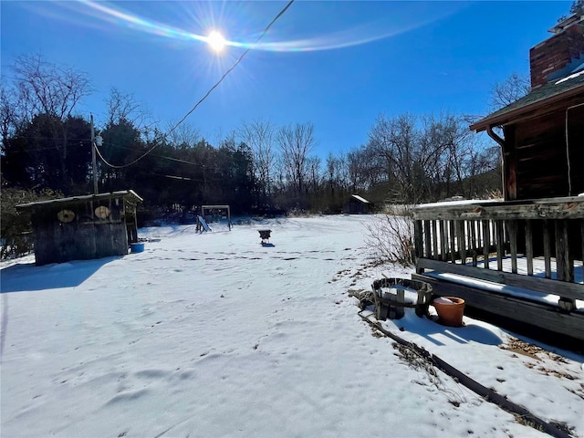 yard layered in snow with a deck