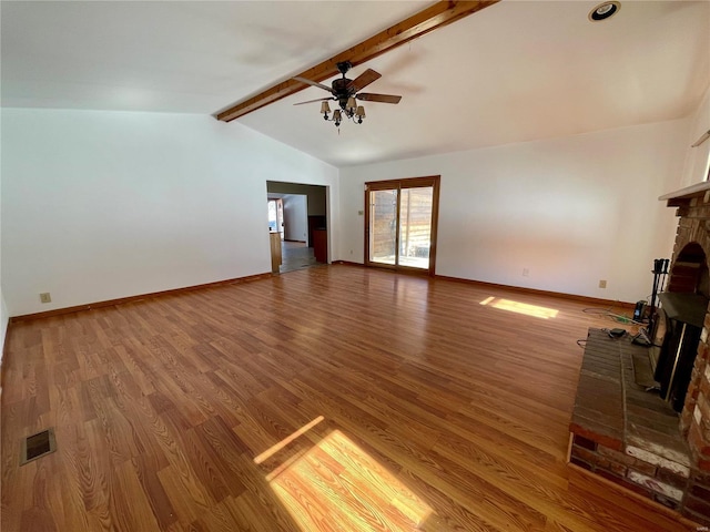 unfurnished living room featuring visible vents, a ceiling fan, wood finished floors, vaulted ceiling with beams, and a fireplace