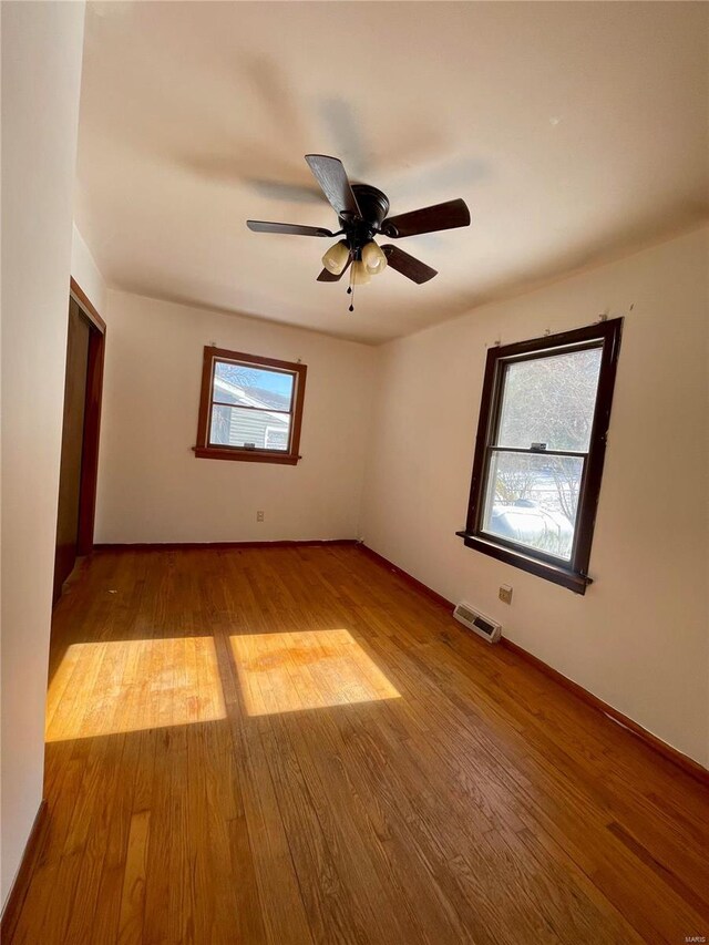 empty room with light wood-style flooring and a ceiling fan